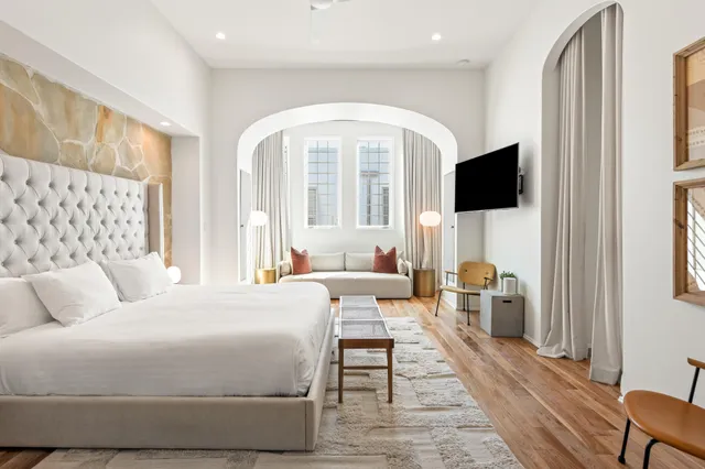 a bedroom with a large bed and a couch