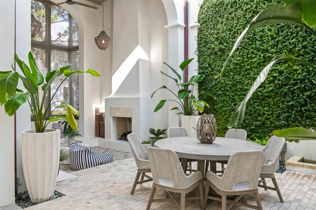 a view of a dining table and chairs in patio