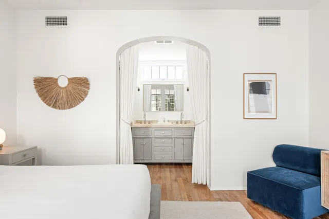 a bedroom with a large bed and a large window