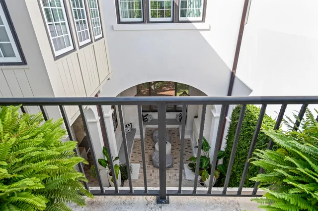 a view of a hallway with wooden floor and a dining room