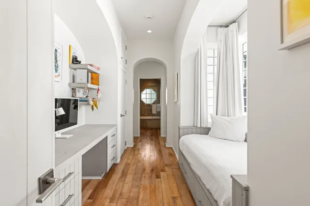 a bedroom with a bed and wooden floor