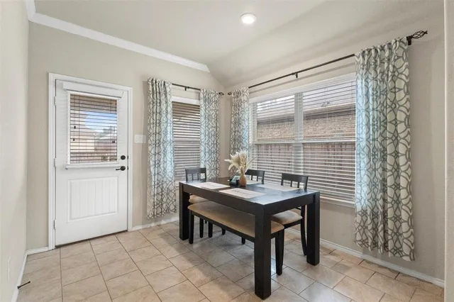 a view of a room that has a table and chairs in it