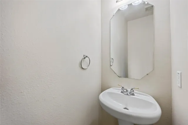 a bathroom with a sink and mirror