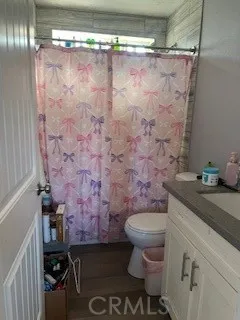 a bathroom with a granite countertop sink toilet and a shower