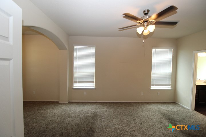 1202 Stonewall Ridge Harker Heights, TX 76548 - Photo 6 of 14 an empty room with windows and chandelier fan