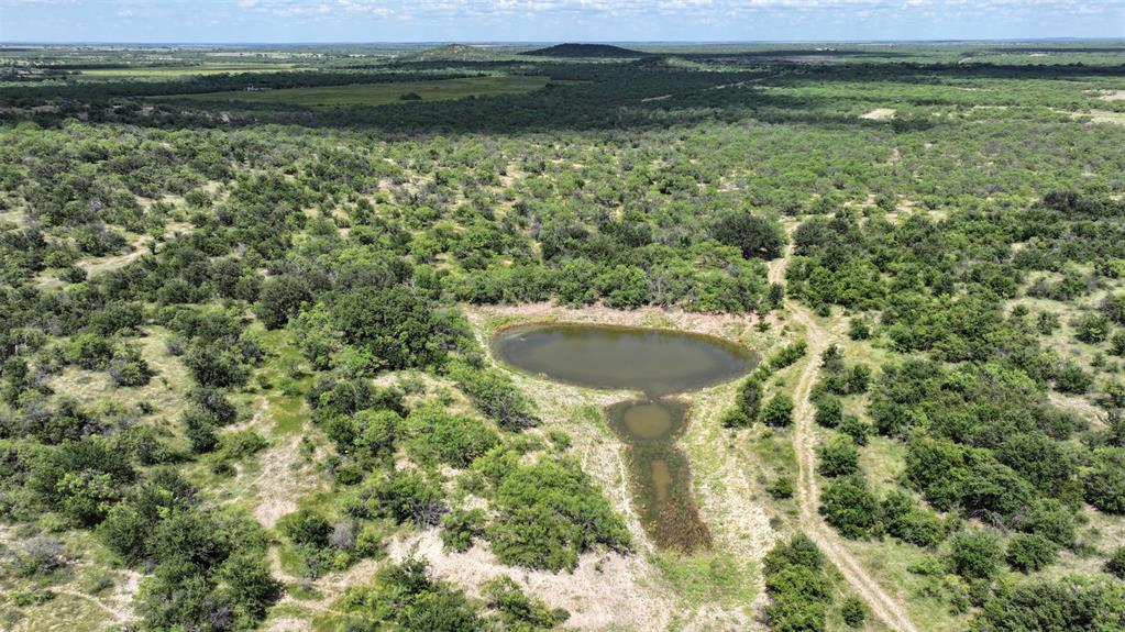 2850 County Road 122 Moran, TX 76464 - Photo 2 of 13 a view of a lake with a house in the background