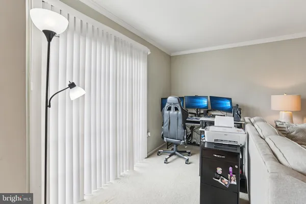 a view of a workspace with furniture and a window