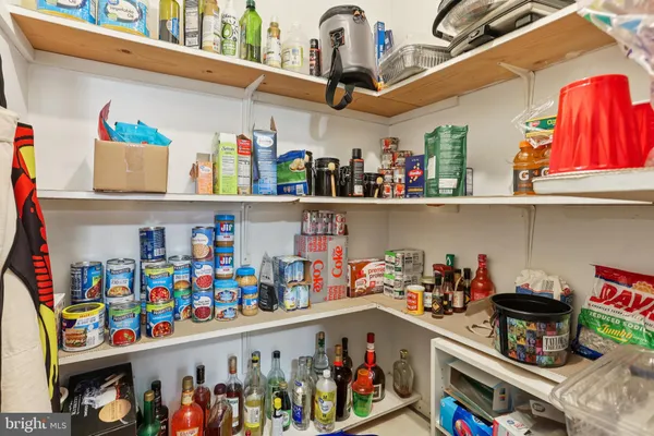 a store room with lots of clutter and cabinets
