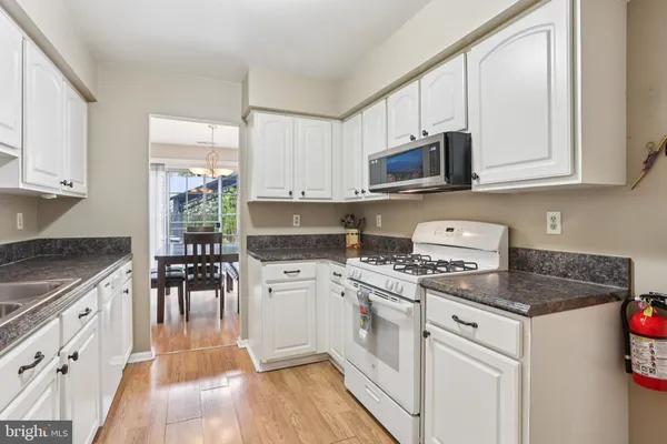 a kitchen with cabinets appliances a sink and a counter top space