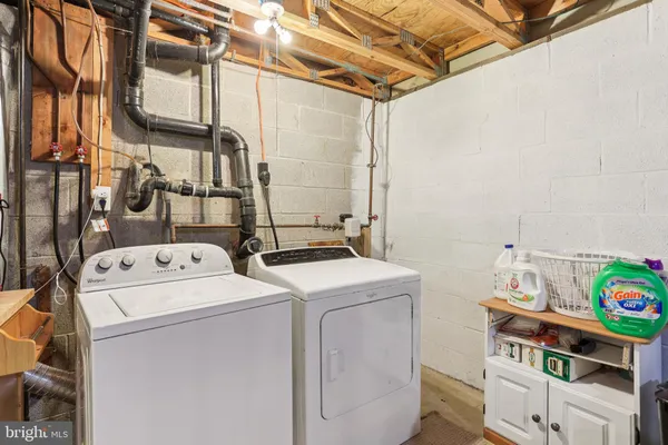 a living room with furniture and a black umbrella