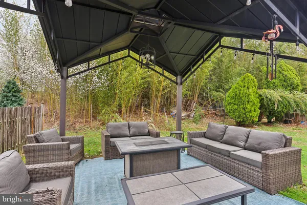 a patio with glass top table and chairs