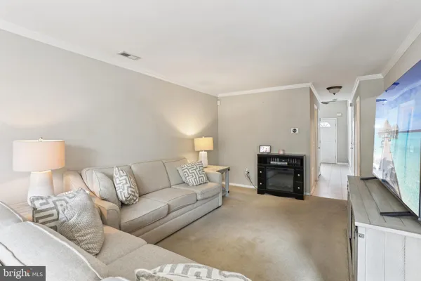 a living room with furniture and a lamp