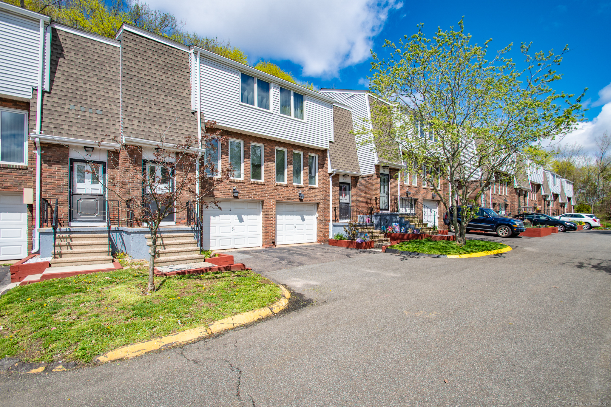 184 Gravel Street, Unit 26 Meriden, CT 06450 - Photo 26 of 27 a front view of a building with small garden