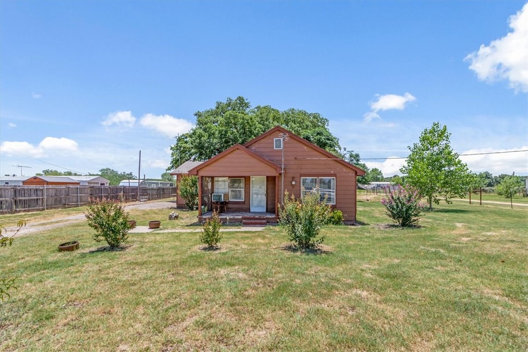 1001 Hamilton Drive Waco, TX 76705 - Photo 1 of 1 a backyard of a house with table and chairs under an umbrella