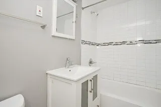 a kitchen with stainless steel appliances white cabinets and a stove top oven