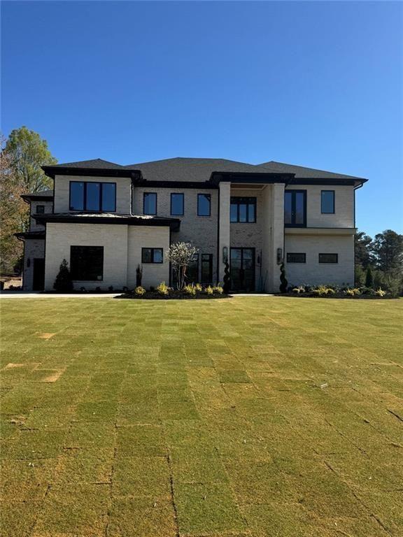3425 Thompson Mill Road Buford, GA 30519 - Photo 15 of 48 a front view of a house with a yard