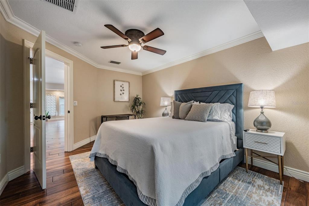 118 10th Avenue North Indian Rocks Beach, FL 33785 - Photo 14 of 31 a bedroom with a bed and a chandelier