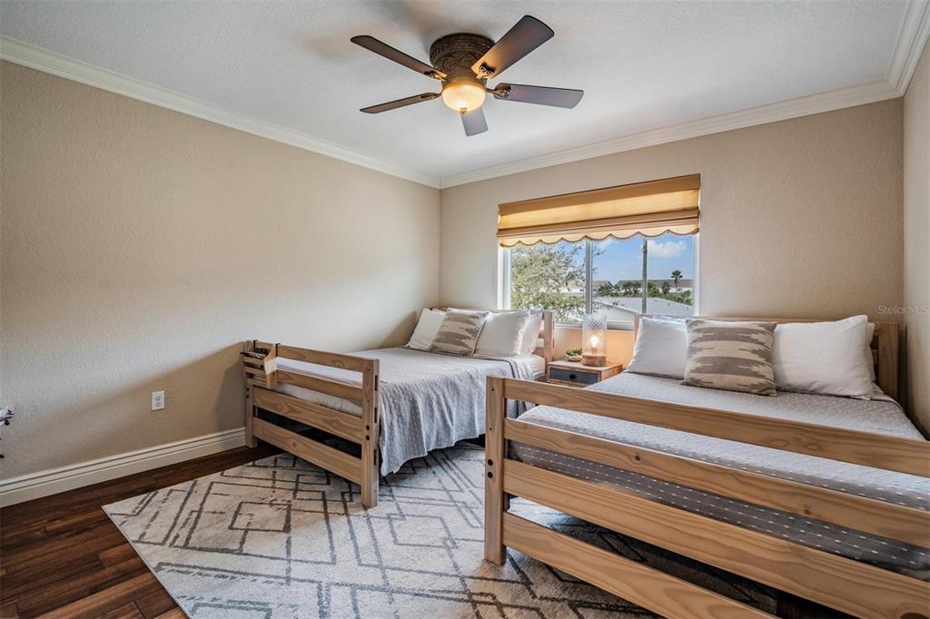 118 10th Avenue North Indian Rocks Beach, FL 33785 - Photo 15 of 31 a bedroom with a bed and a chandelier