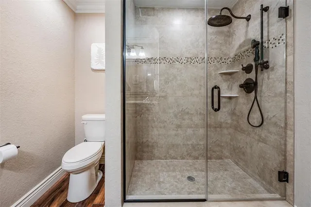 a bathroom with a toilet and a shower