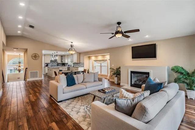 a living room with furniture a fireplace and a flat screen tv