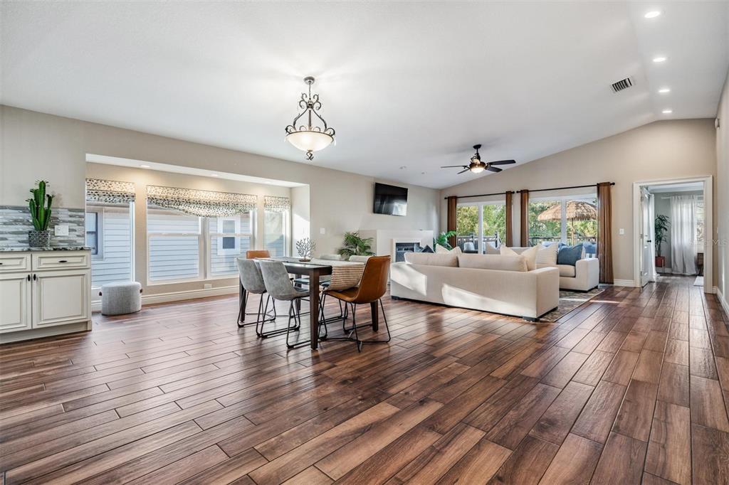 118 10th Avenue North Indian Rocks Beach, FL 33785 - Photo 6 of 31 a living room with furniture dining table and wooden floor