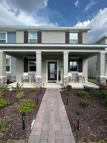 a front view of a building with garden