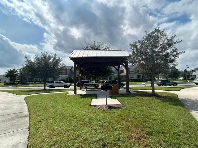 a view of a house with entertaining space and a small garden