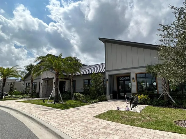 a living room with furniture a flat screen tv and a large window