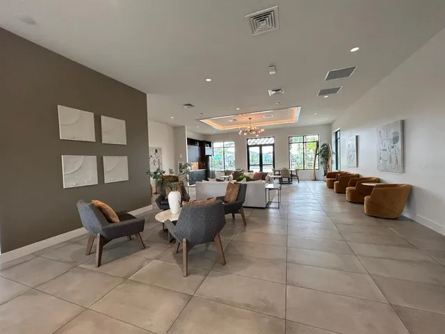 a lobby with furniture and a potted plant
