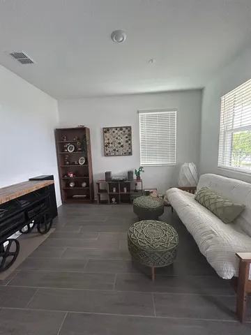 a living room with furniture and a window