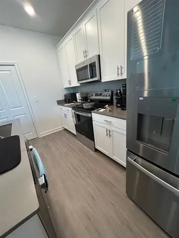 a kitchen with granite countertop a stove and a microwave