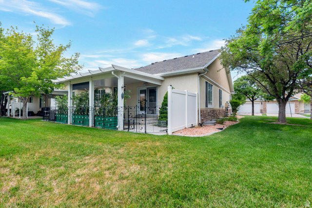 1092 Tithing Ridge Drive Riverton, UT 84065 - Photo 24 of 25 Rear exterior featuring a covered patio with white pergola, stucco siding, and stone accents