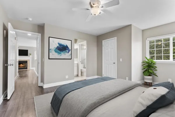 a bedroom with a large bed and a chandelier