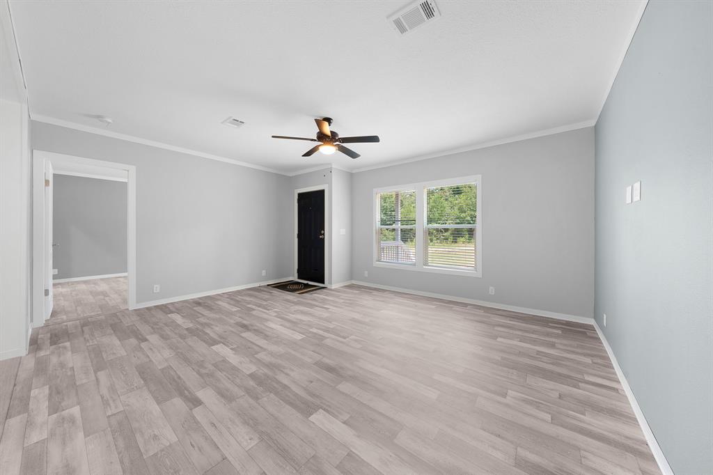 109 3900th Road Gilmer, TX 75644 - Photo 15 of 35 a view of an empty room with a window and wooden floor