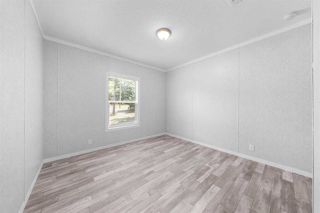 109 3900th Road Gilmer, TX 75644 - Photo 23 of 35 a view of room with window and hardwood floor
