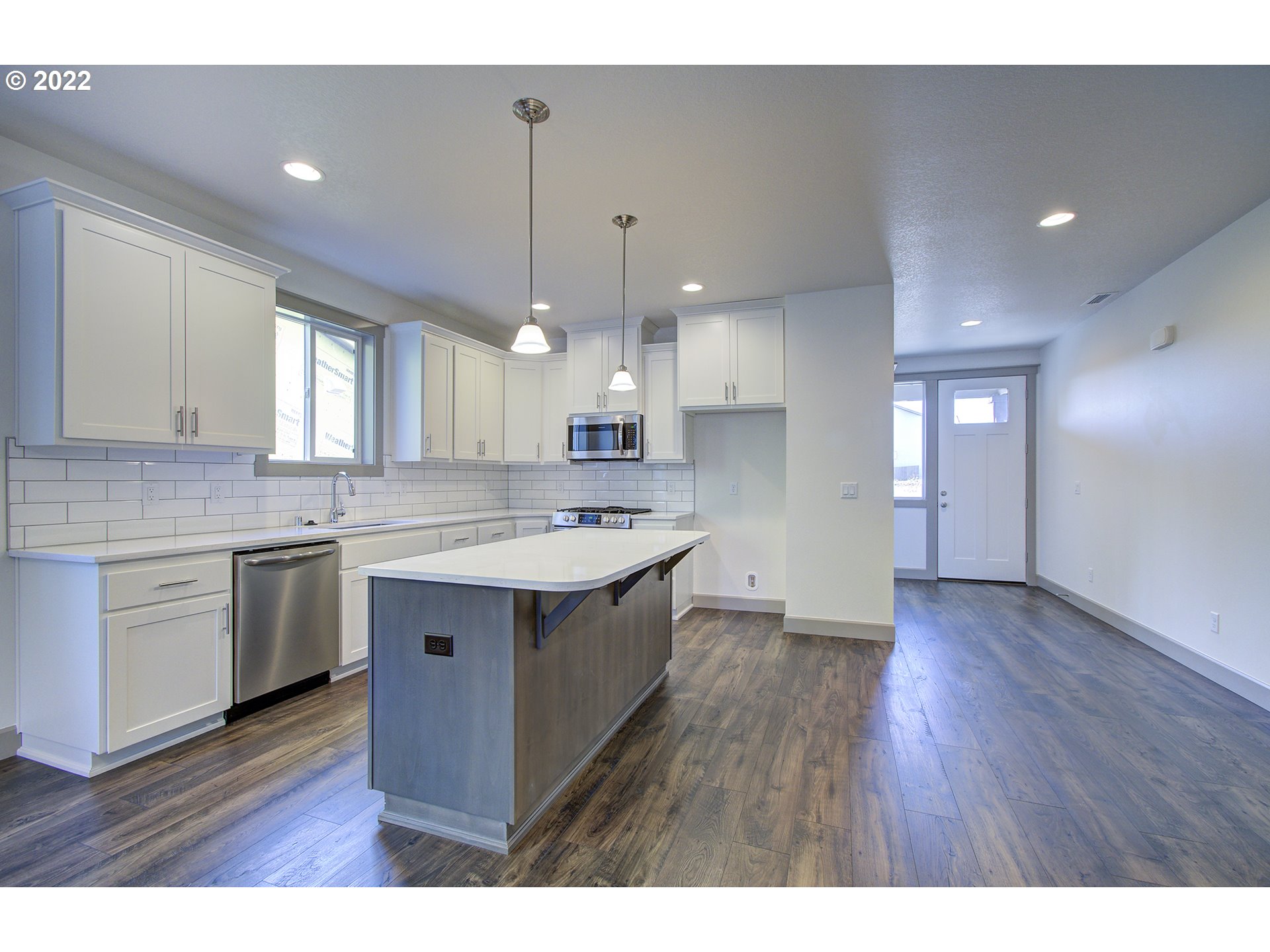 200 North 22nd Court Ridgefield, WA 98642 - Photo 7 of 32 a kitchen with a sink cabinets and wooden floor