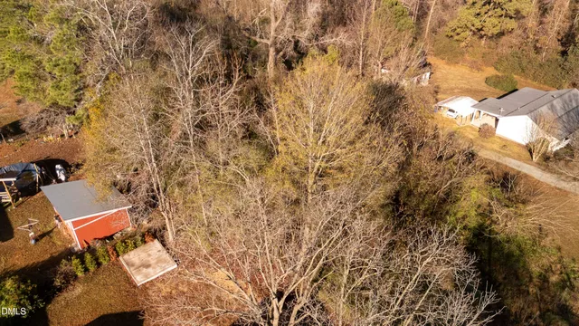 a view of a yard with wooden fence