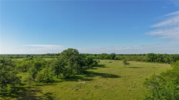 an aerial view of a houses with a yard