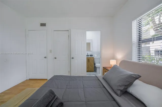 a bedroom with a bed and a window