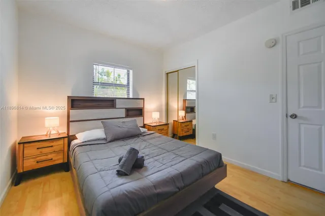 a bedroom with a bed and wooden floor