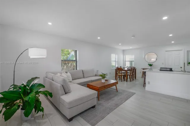 a living room with furniture and a potted plant