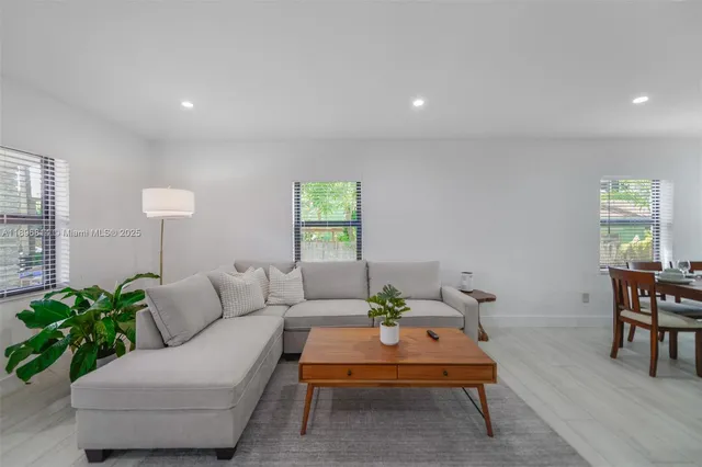 a living room with furniture and a potted plant