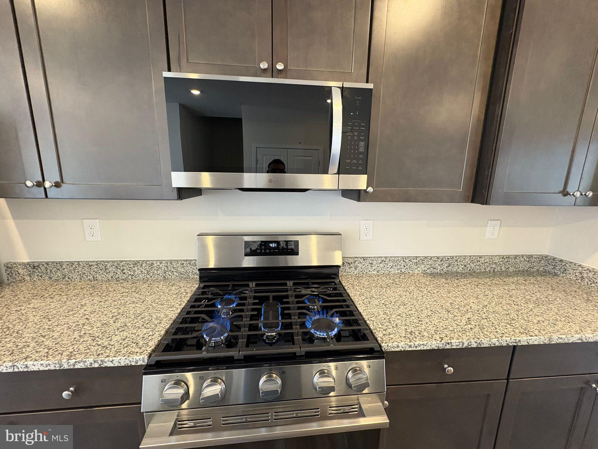 1744 Water Xing Road Baltimore, MD 21208 - Photo 2 of 12 a kitchen with a stove and a microwave
