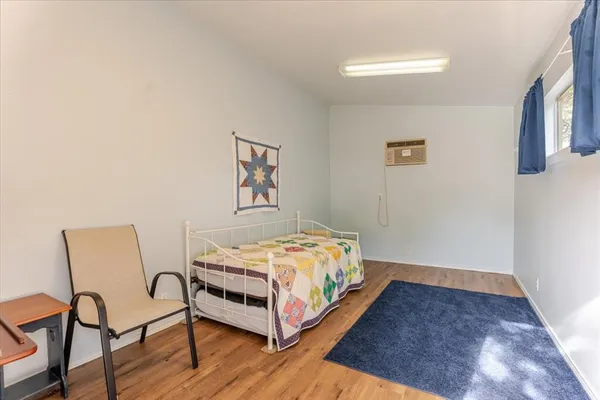 a bedroom with a bed and chair