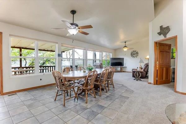 a dining room with furniture window and outside view
