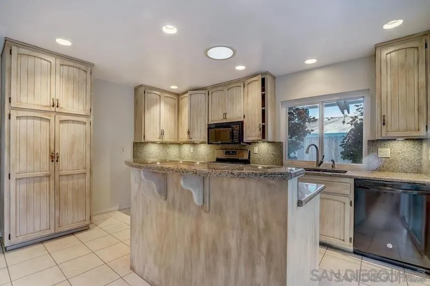 14550 Dehia Street Poway, CA 92064 - Photo 2 of 15 a kitchen with stainless steel appliances granite countertop a refrigerator and a sink