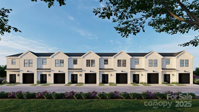 a front view of a residential houses with yard and green space