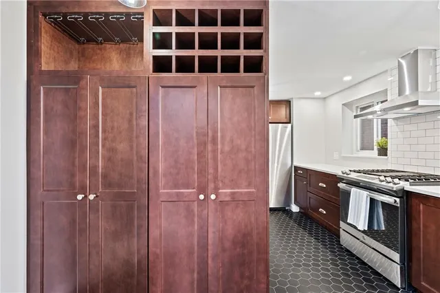 a kitchen with a refrigerator and a stove