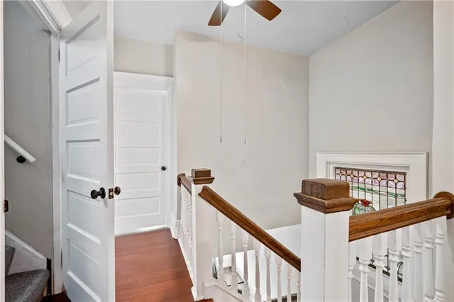 a view of a hallway with wooden floor and staircase
