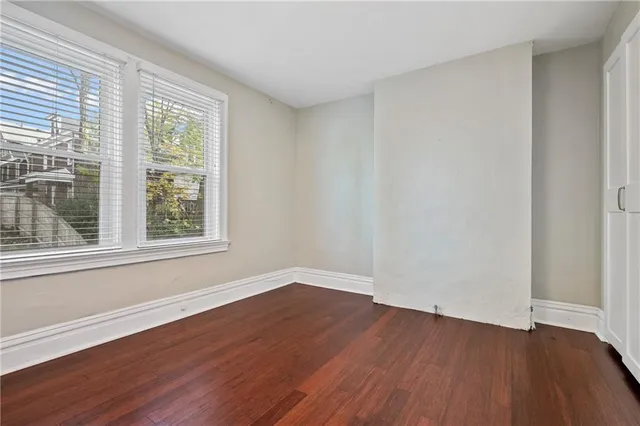 wooden floor in an empty room with a window
